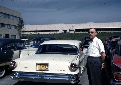 S0720 man at car (Ted Dimke Dayton Ohio) near factory